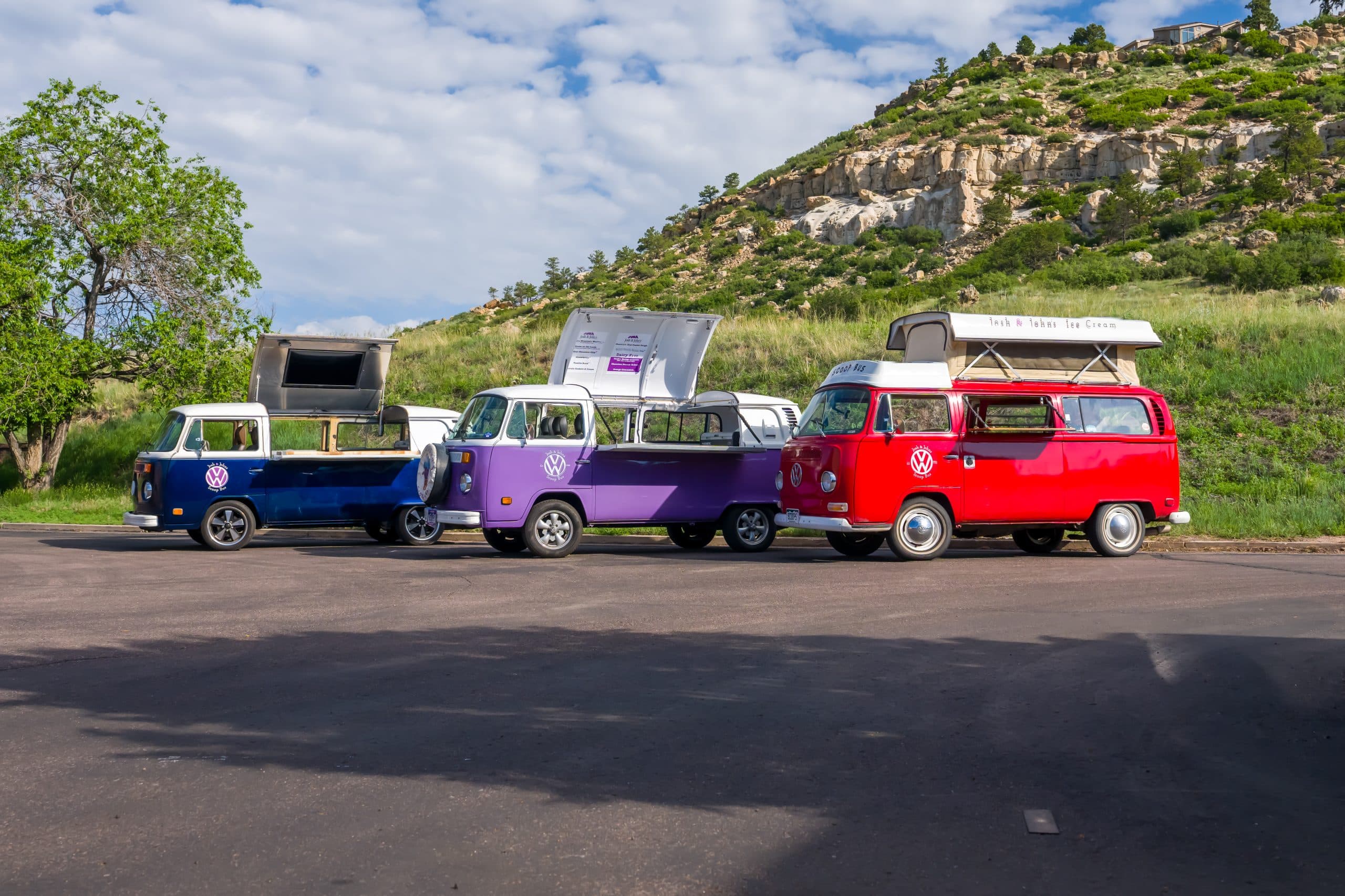a row of colorful buses parked on a road