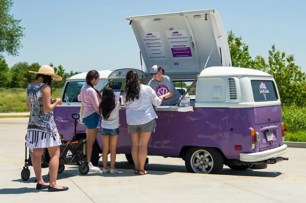 a group of people standing around a van